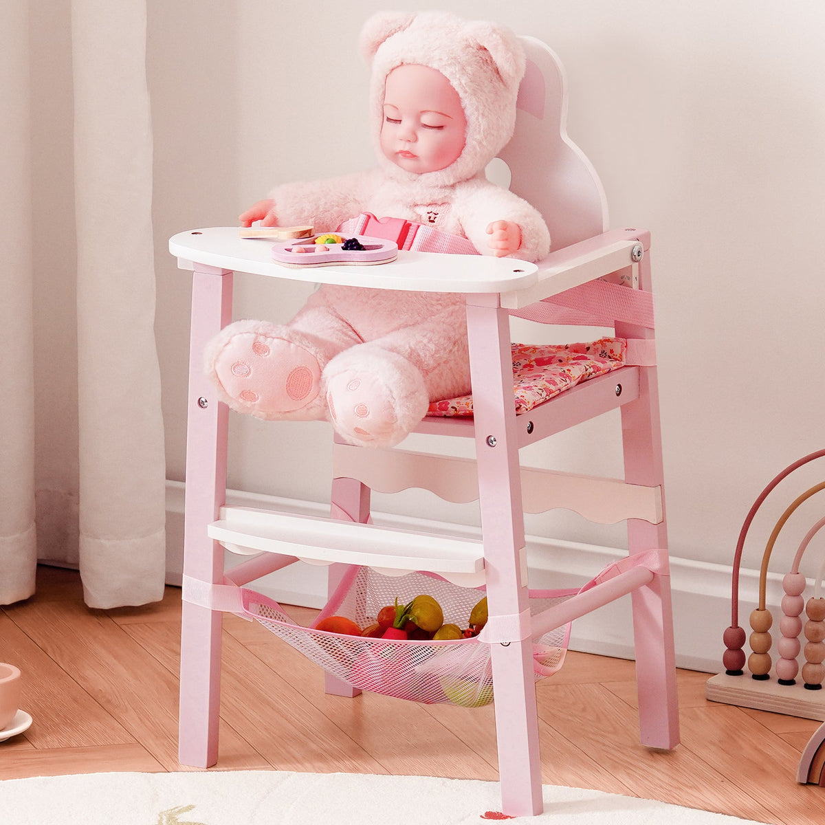 Young girl in pink outfit laughing beside ROBUD 18 inch Doll High Chair with adorable bunny design sitting on pink rug