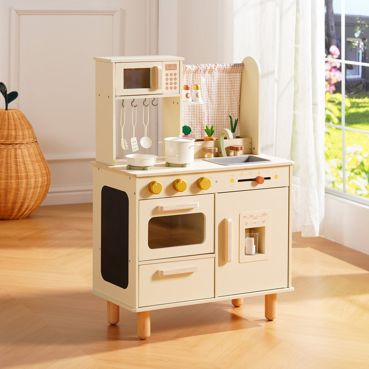 ROBUD cream wooden play kitchen with oven, microwave, and pot rail, displayed in a bright sunlit playroom.