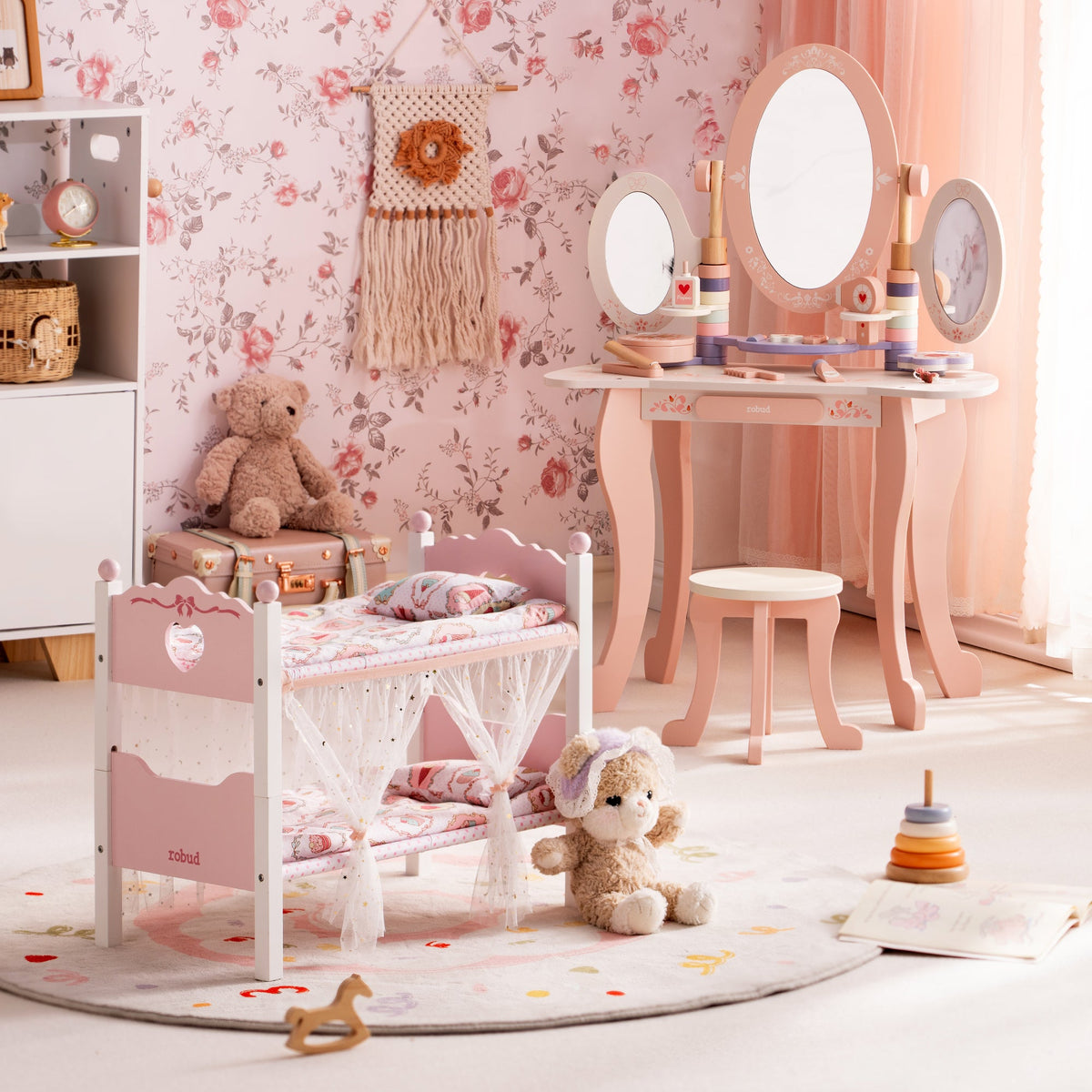 ROBUD white doll bunk bed and pink wooden vanity with tri-fold mirror in a floral wallpaper room with a plush teddy bear.