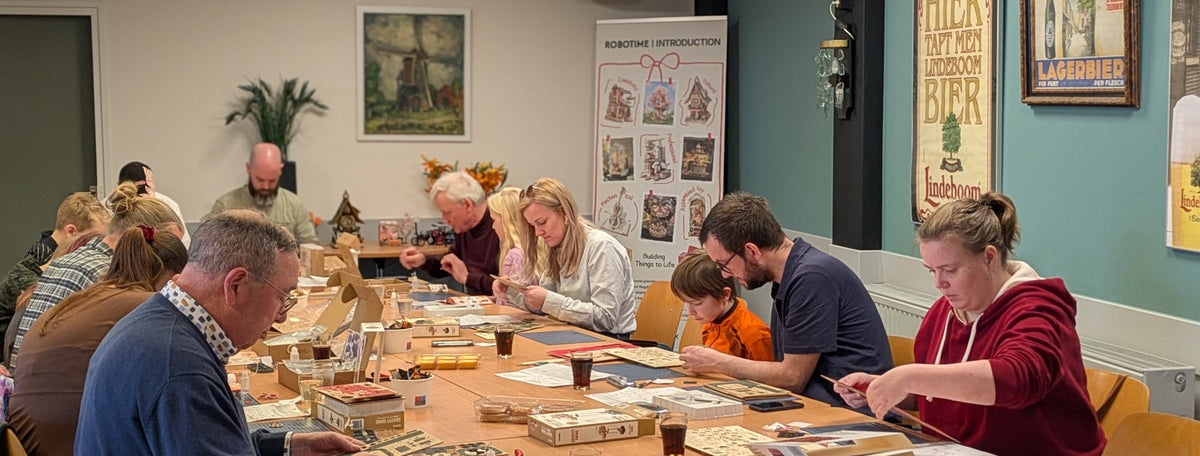 Robotime community event showing participants focused on building wooden kits at tables with Robotime banners and display