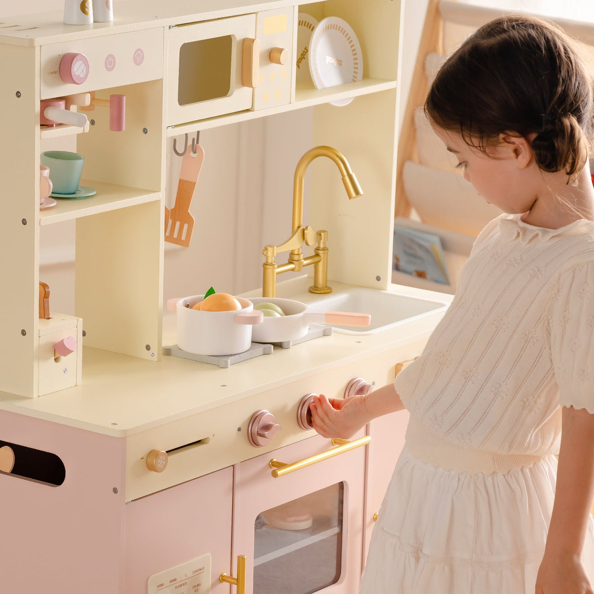 ROBUD Pink Baking Kitchen with girl in white dress turning golden faucet at the double sink with upper open shelving display