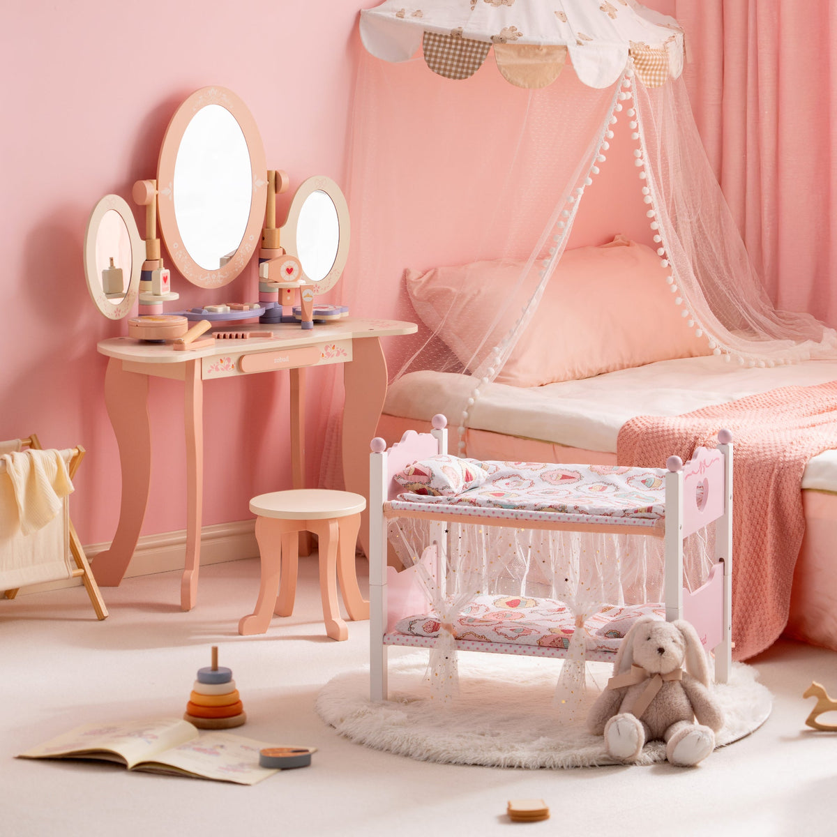 ROBUD white wooden doll bunk bed and pink kids vanity displayed together in a pink room beneath a full-size canopy bed.