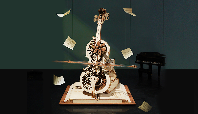 Robotime wooden cello model on a dark stage with floating sheet music and bow details