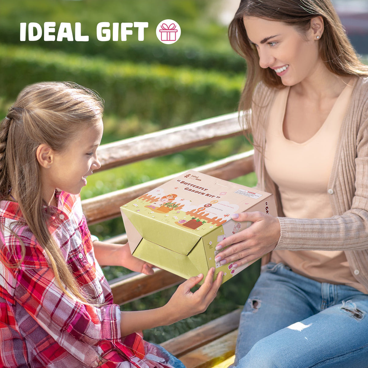 Mother and daughter on a wooden bench with ROBUD Kids Gardening Set retail box showing ideal gift moment outdoors