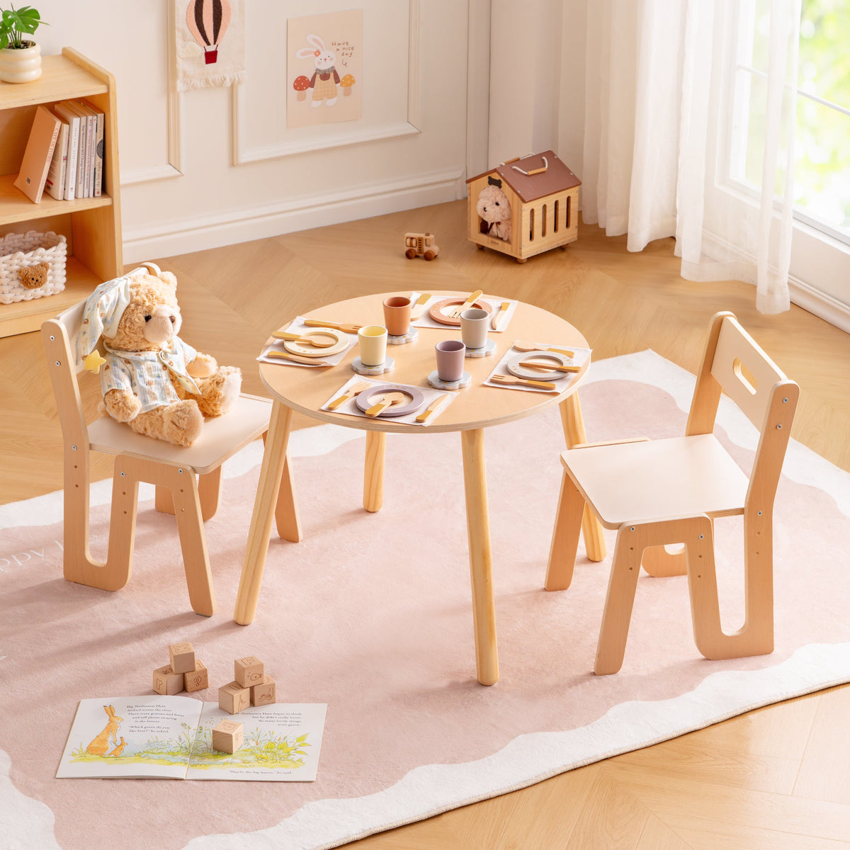 Natural wood ROBUD Glowwood round table with two chairs and a teddy bear seated in a bright playroom setting.