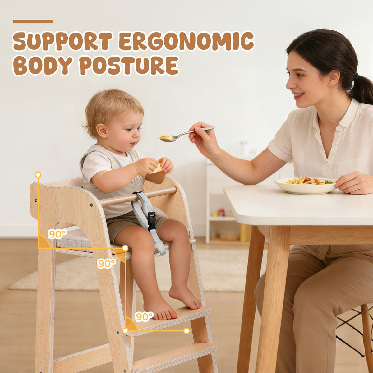 Baby seated in a ROBUD natural wood high chair being spoon-fed by a smiling mother at the dining table.