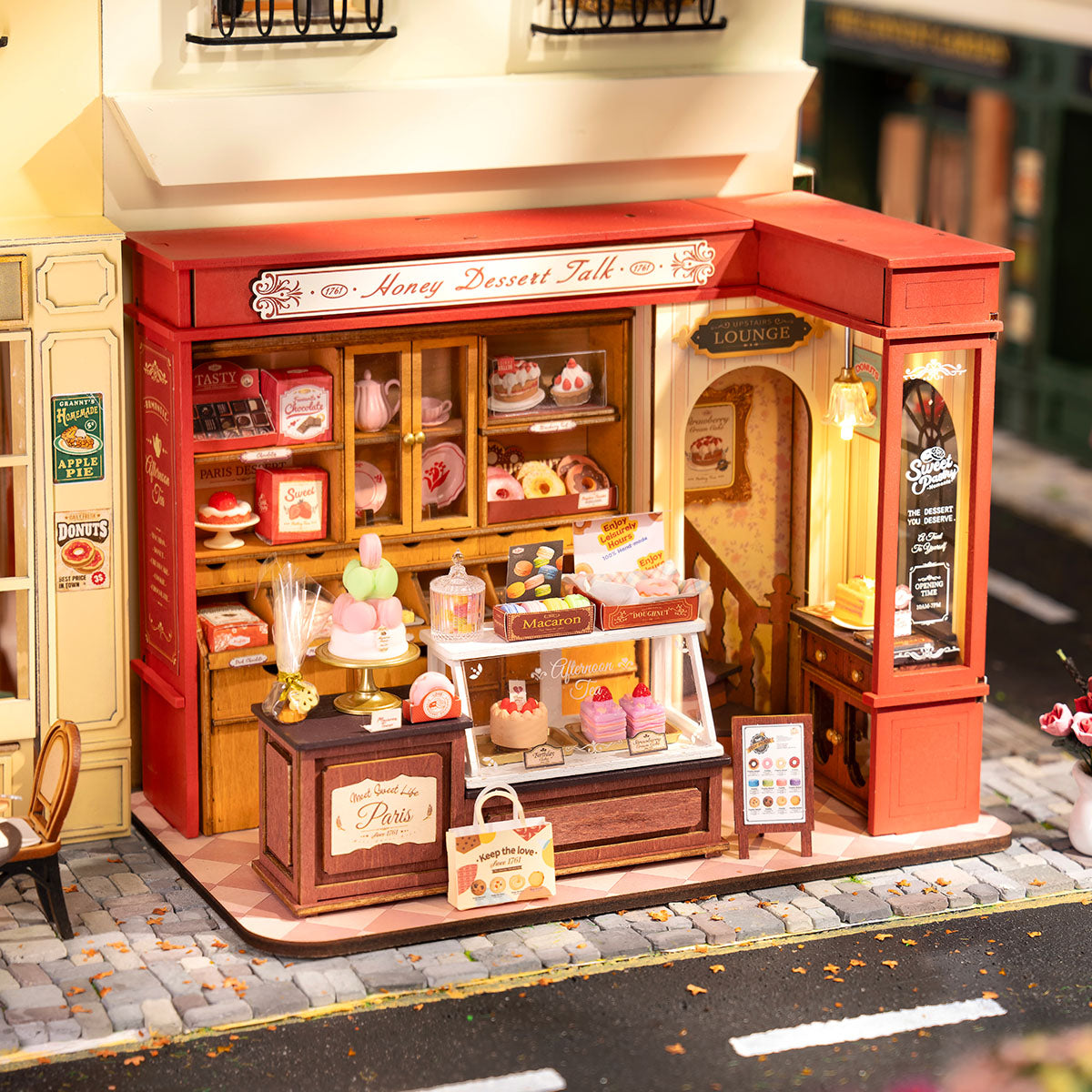 Rolife Honey Dessert Talk DG168 completed miniature dessert shop placed on a table in warm outdoor diorama scene