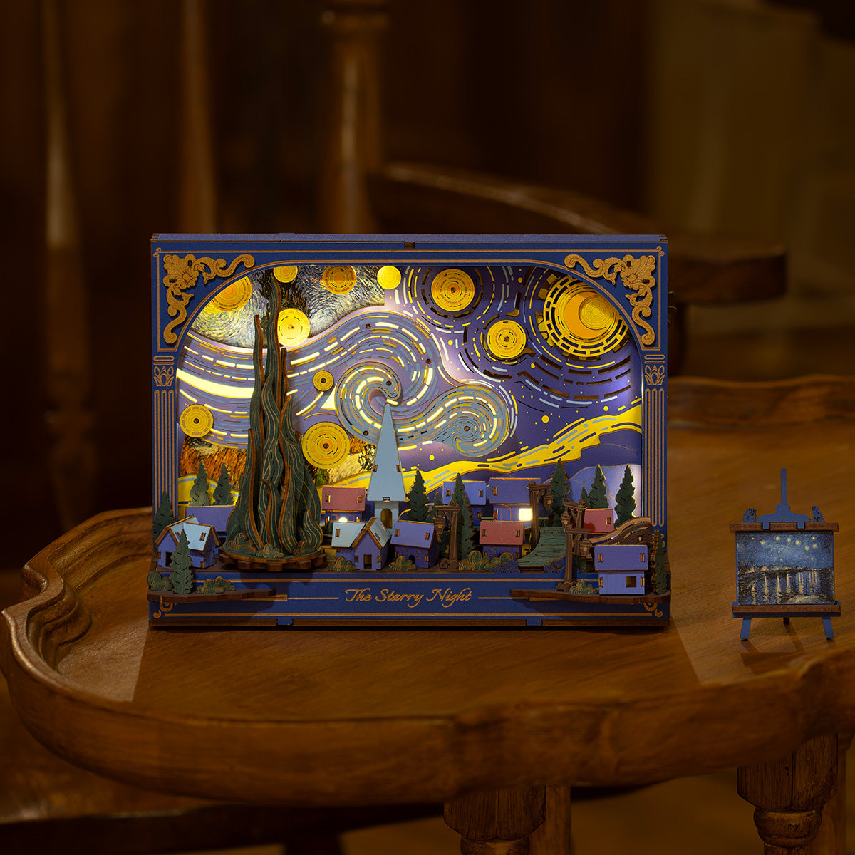Rowood The Starry Night 3D wooden wall art puzzle TH003 lit on a wooden table, deep blue and gold Van Gogh swirl design