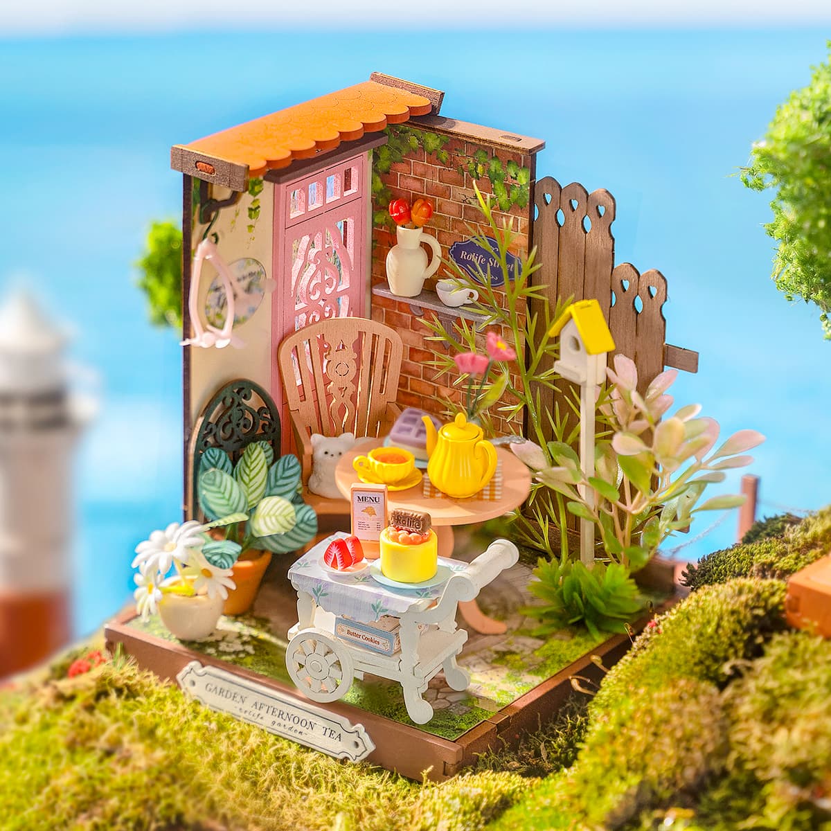 Rolife miniature garden tea yard scene with green pergola, pink chair, dessert cart and ocean backdrop