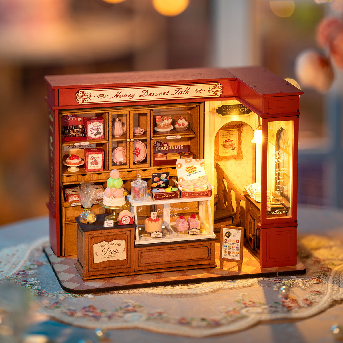Rolife Honey Dessert Talk DG168 miniature shop interior with warm lighting, pink signage and sweets display on counter