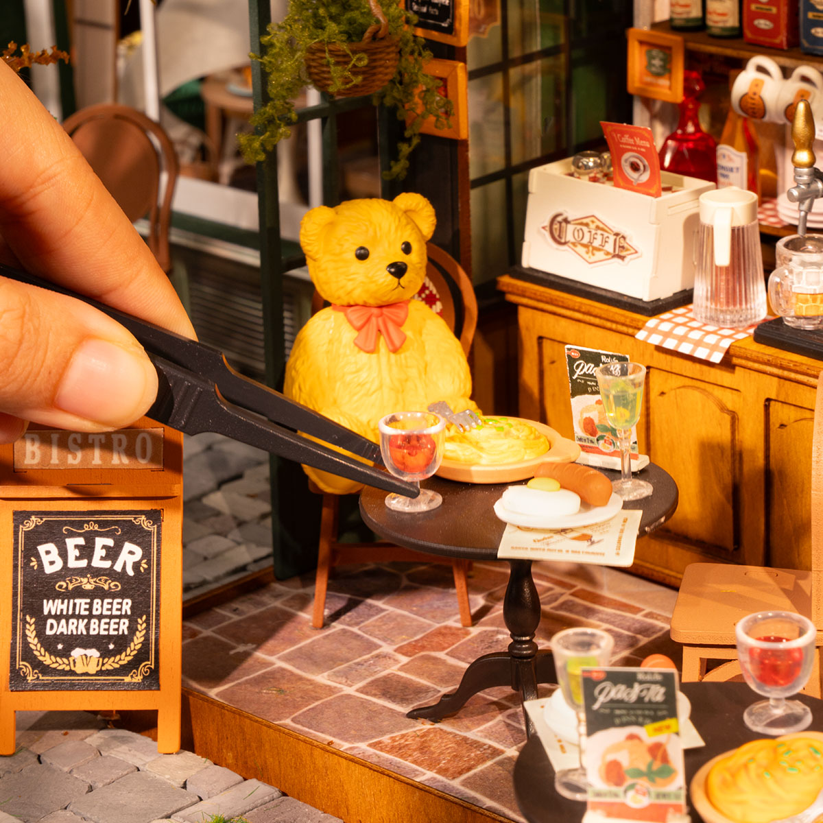 Rolife Tipsy Restaurant DG167 interior scene with miniature pop-figure bartender serving a plush bear at the coffee bar with beer taps and shelved bottles