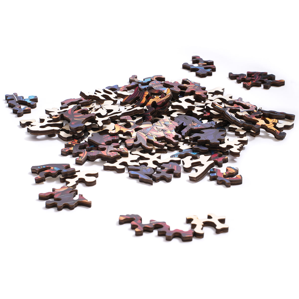 Animal-shaped wooden puzzle pieces in dark wood tones scattered loosely in a pile on a white surface