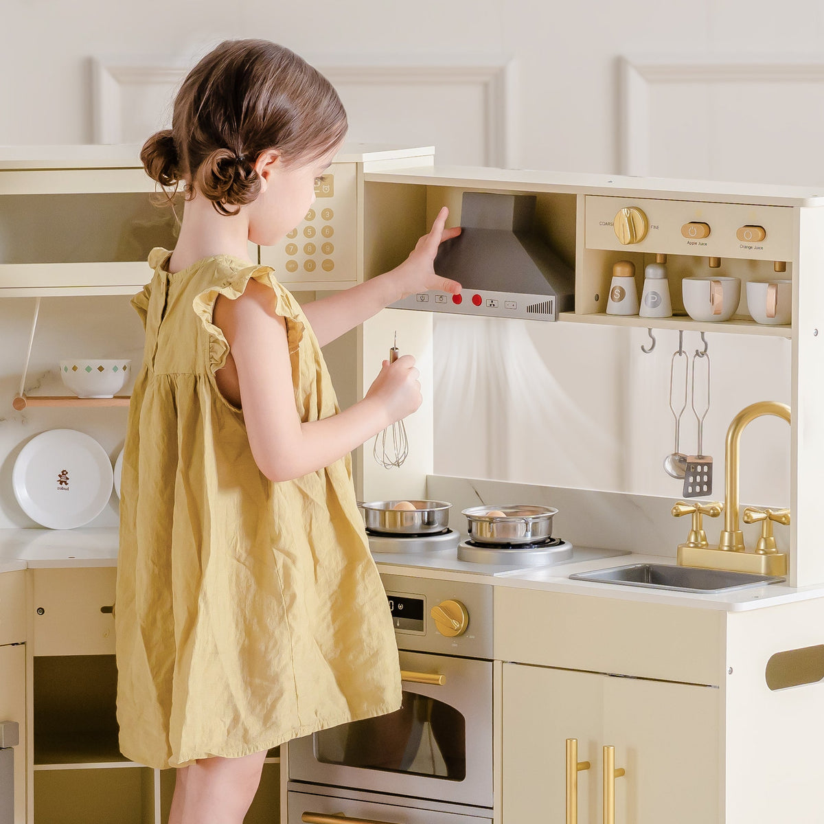 Young girl reaching into overhead cabinet of ROBUD Light Luxury Corner Play Kitchen with range hood and cookware hooks