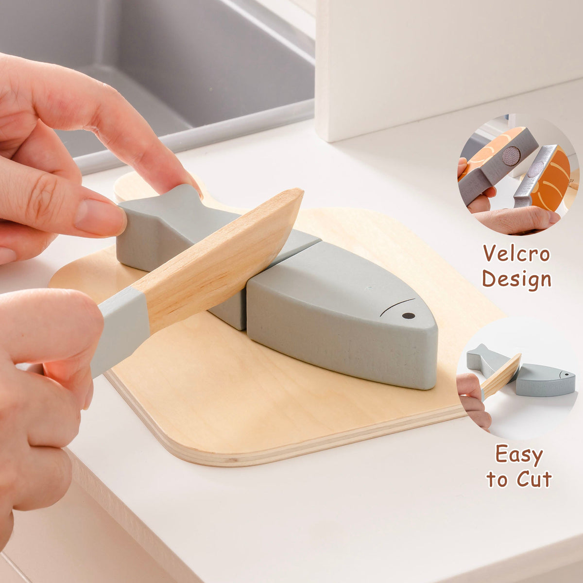 ROBUD wooden meat cutting food playset velcro detail showing grey herring fish being cut with a wooden knife on a cutting board, velcro design and easy-to-cut callouts visible