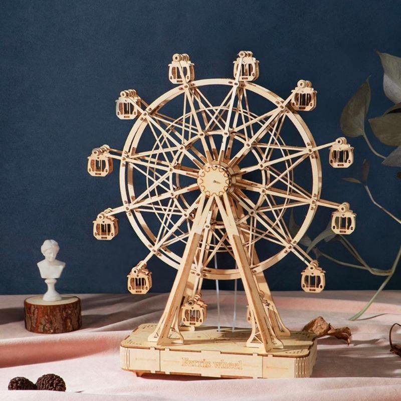 Rolife Ferris Wheel TGN01 music box on a dark shelf with a marble bust figurine and warm ambient studio lighting