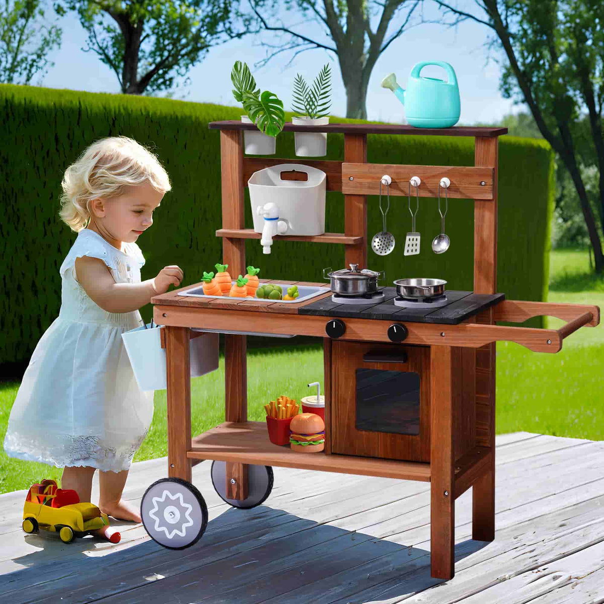 Toddler girl in white dress cooking at a ROBUD outdoor wooden mud kitchen in a green garden with real accessories