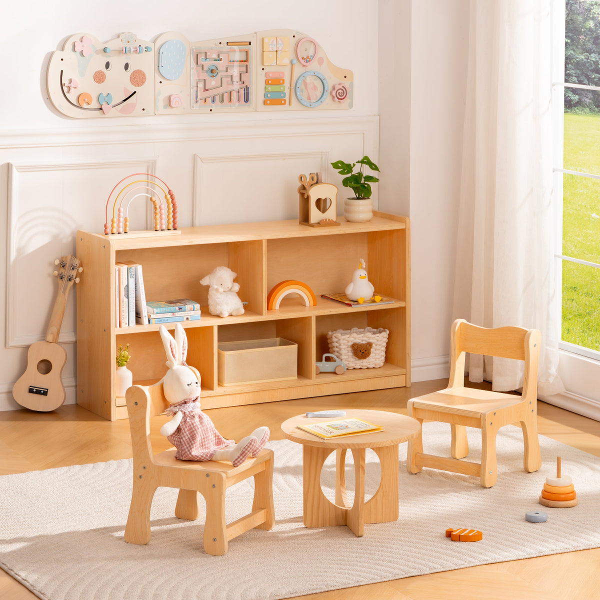 ROBUD play set featuring wooden bookshelf two natural chairs a small round table and an activity board in a bright room.