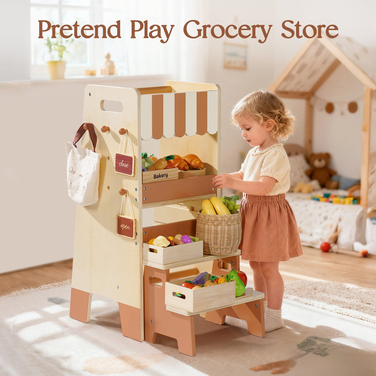 Toddler girl using ROBUD Toddler Standing Tower converted as a pretend grocery store in a sunny playroom with wooden toys