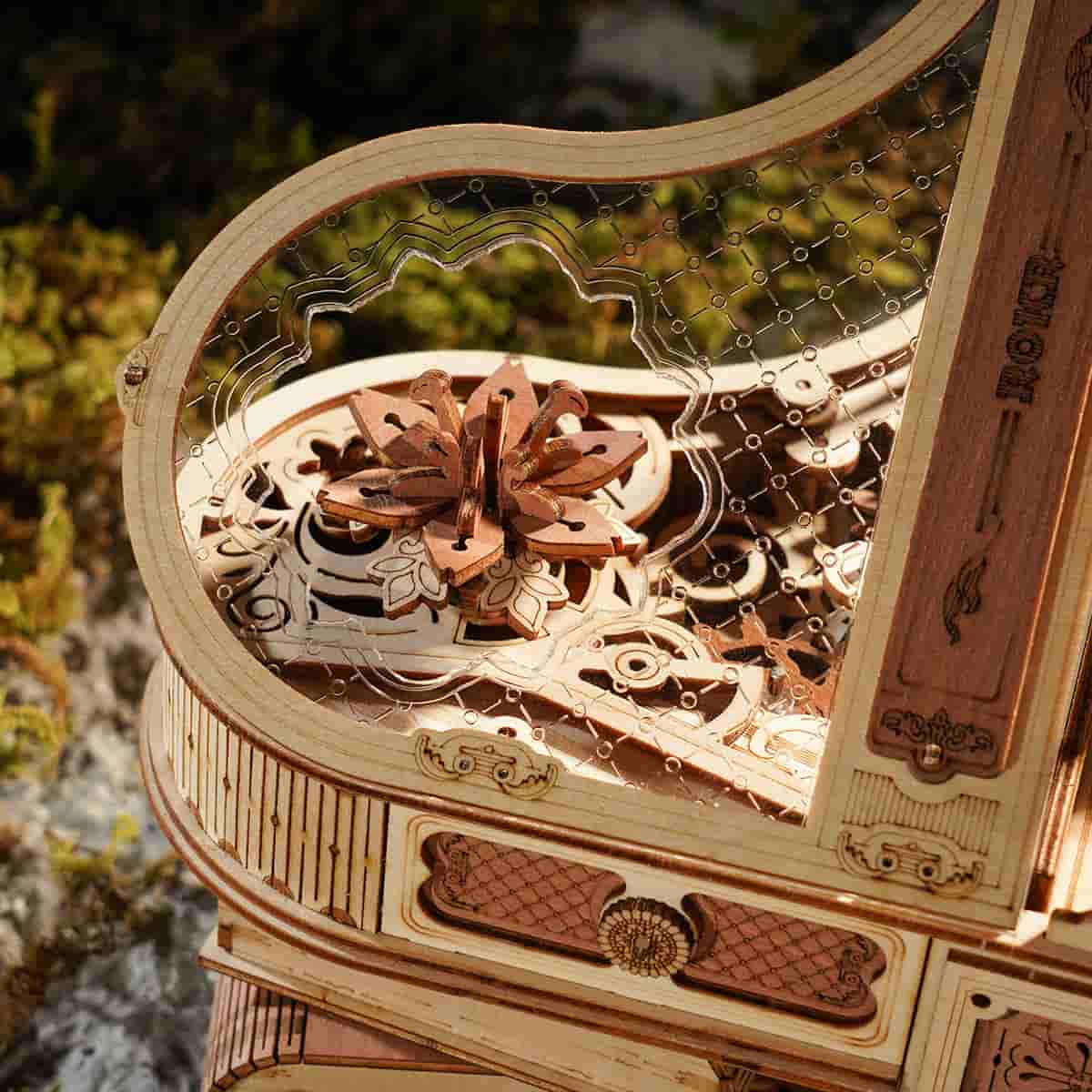 ROKR Magic Piano AMK81 close up of the detailed piano keyboard keys and ornate carved wooden base with scrollwork legs and piano bench
