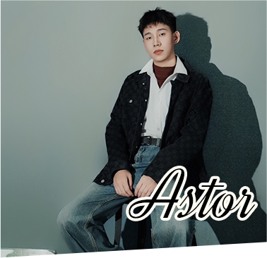 Promotional portrait of model named Astor seated in casual style against a neutral grey backdrop for Robotime Online brand campaign