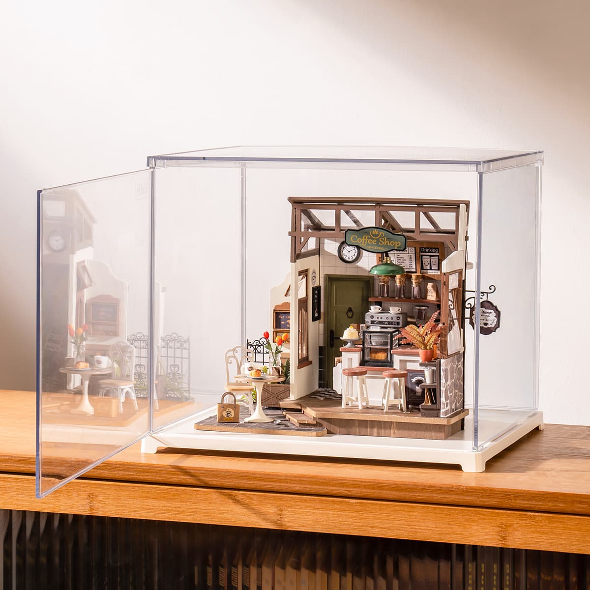 Rolife cafe miniature in a clear display box is shown at an angle on a cabinet.