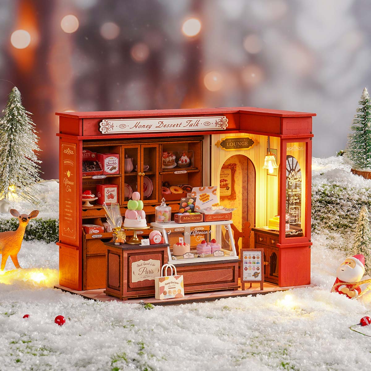Rolife Honey Dessert Talk DIY miniature house with illuminated sweet shop storefront and display window on a snowy holiday scene