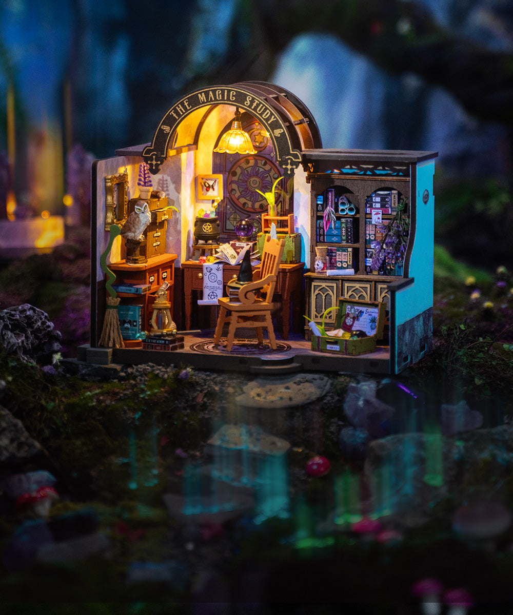 Rolife Magic Study DIY miniature dollhouse book nook with an illuminated wizard study and bookshelf placed in a misty forest setting.