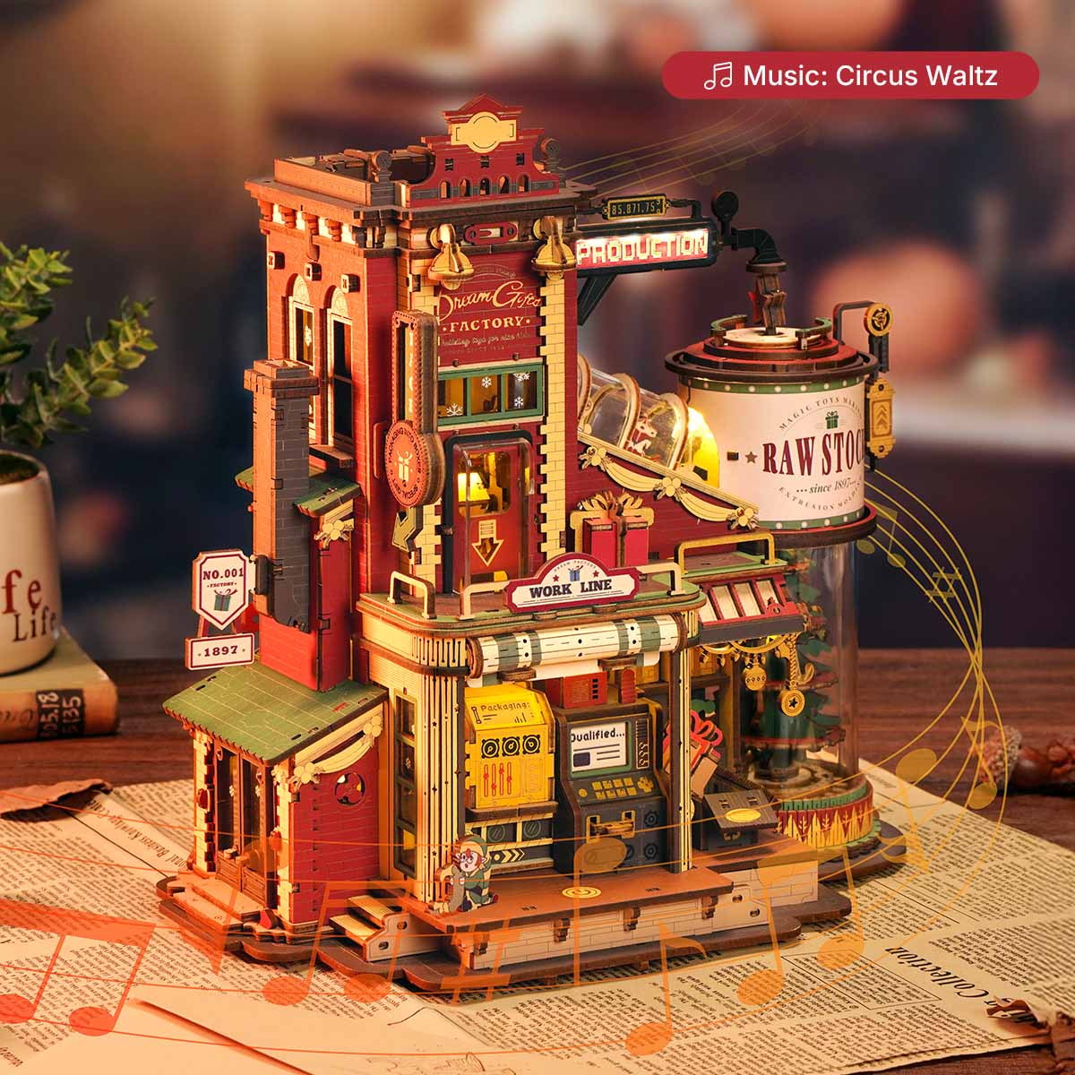 ROKR Dream Gift Factory EAB01 lifestyle shot showing the glowing factory scene placed on a newspaper in warm ambient light with music note graphics