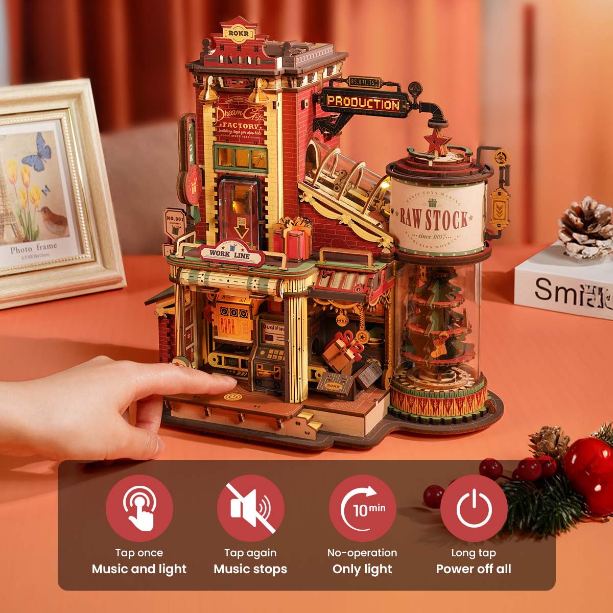 ROKR Dream Gift Factory EAB01 hand touching the wooden base to activate touch-control lighting with Circus Waltz music and LED glow diagram
