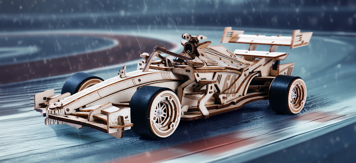 ROKR Racing Car 3D wooden puzzle LK505 assembled natural wood Formula-style race car with rubber tires and driver figure displayed on a wet racing circuit background