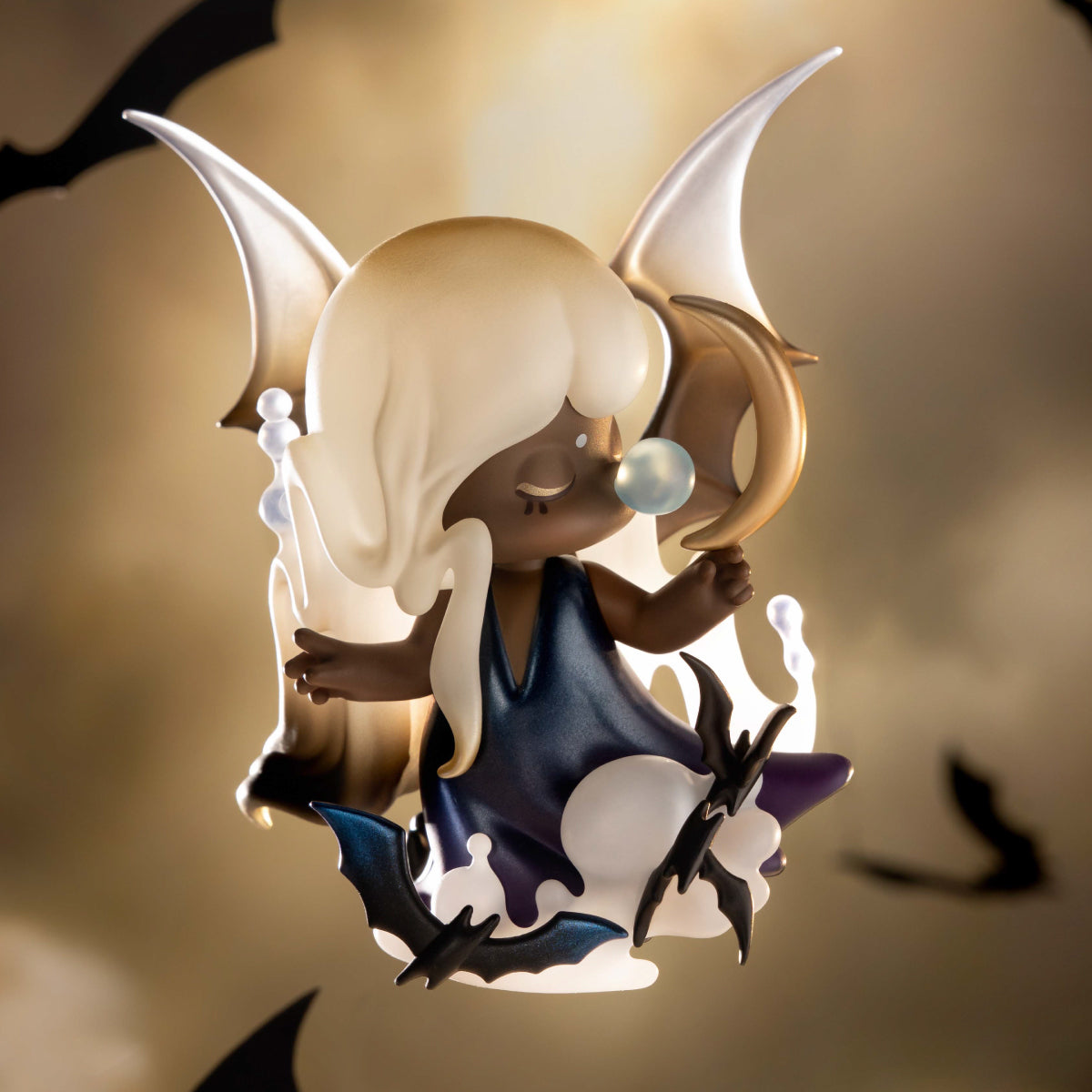 Figurine with large bat wing ears and a blue dress, surrounded by flying bats against a cloudy sky