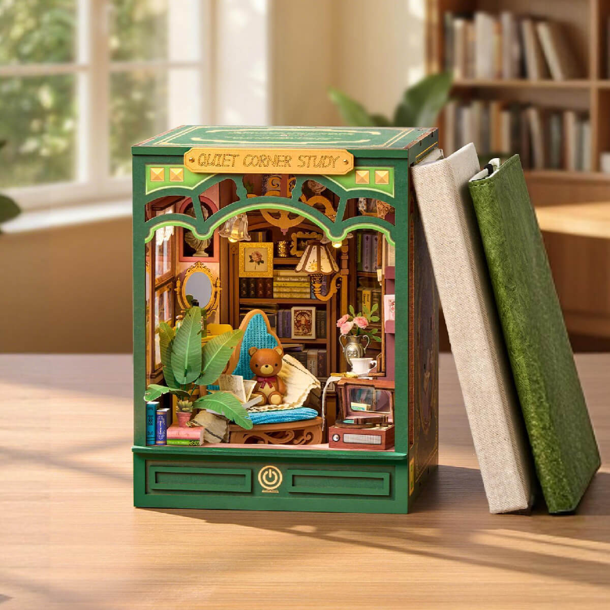 Rolife Quiet Corner Study book nook displayed between two upright books on a light wooden shelf in a bright room