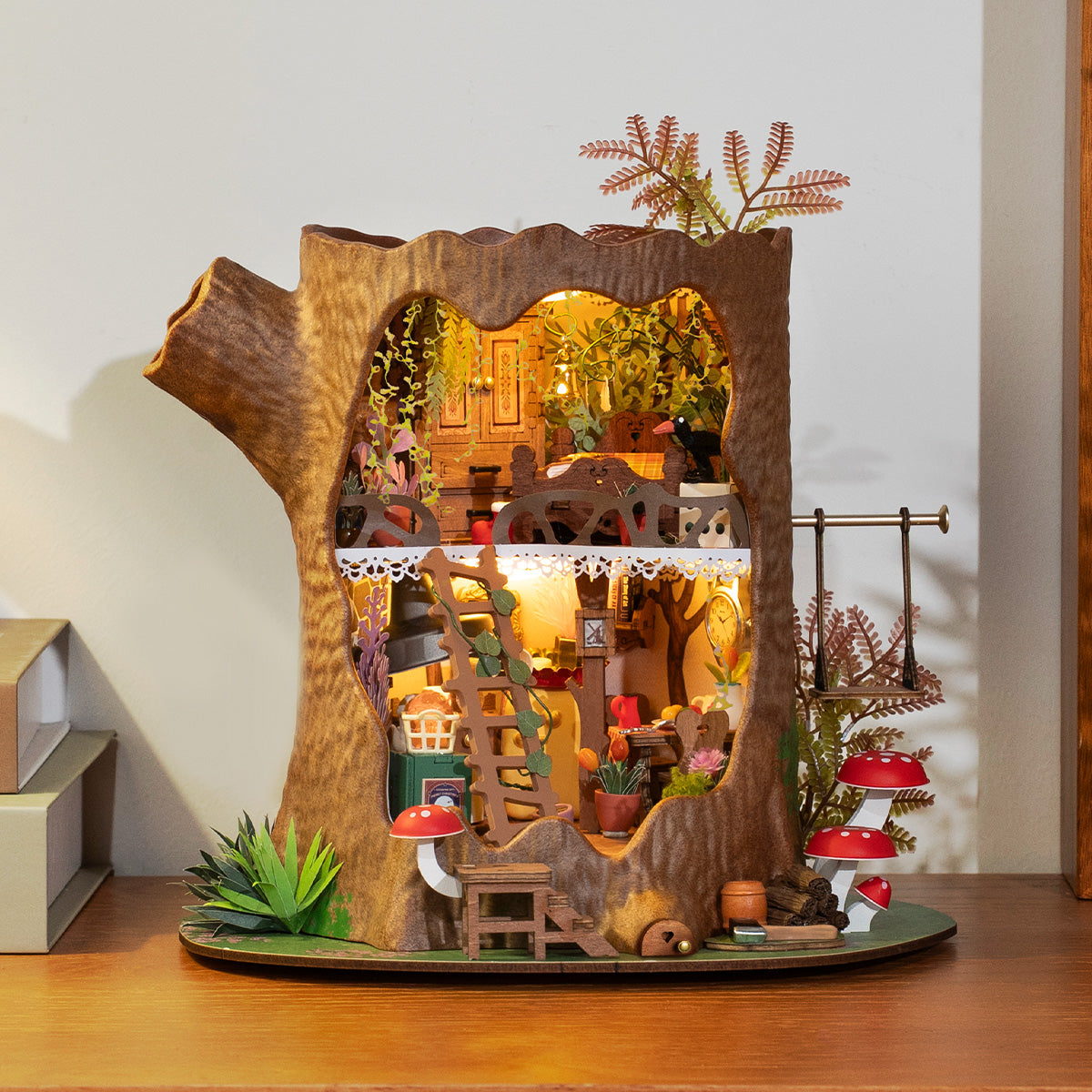 Rolife Fairytale Tree House DG179 miniature base garden close-up with red polka-dot mushrooms, a sleeping fox, honey pot, vine ladder, white rabbit, and potted plants