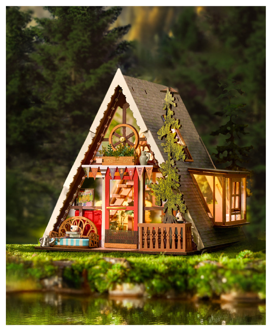 Rolife A-Frame Cabin DIY Miniature House DG181 illuminated triangular wooden cabin nestled among dark pine trees at dusk.