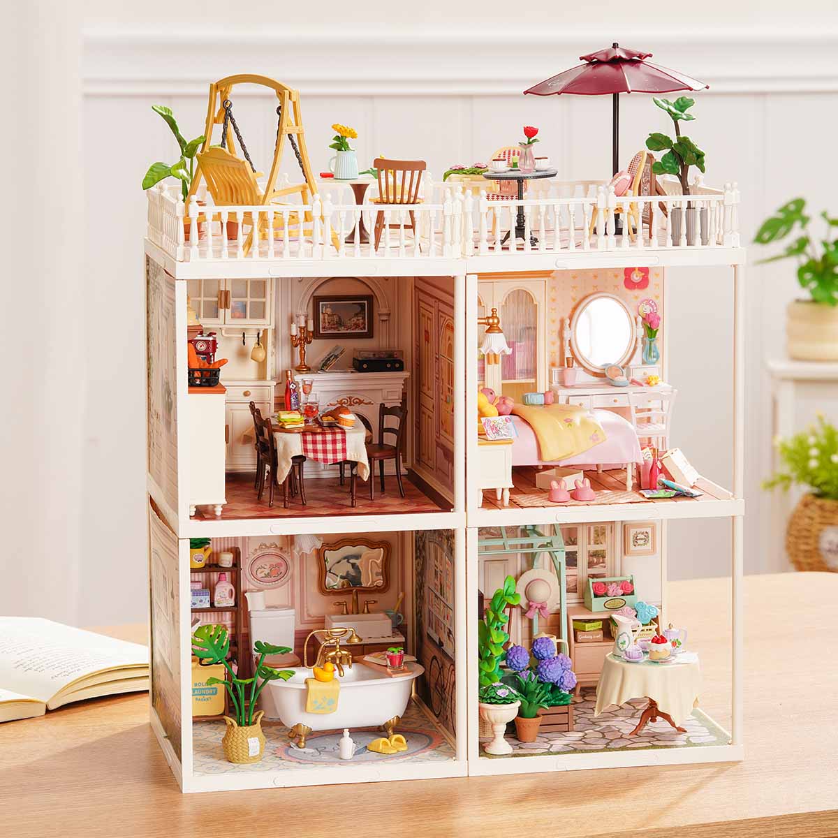 Rolife Super Creator Series 4-in-1 Four Grid miniature with two rooftop balconies and four furnished rooms including bedroom, bakery, bathroom, and flower shop in a wide white frame.