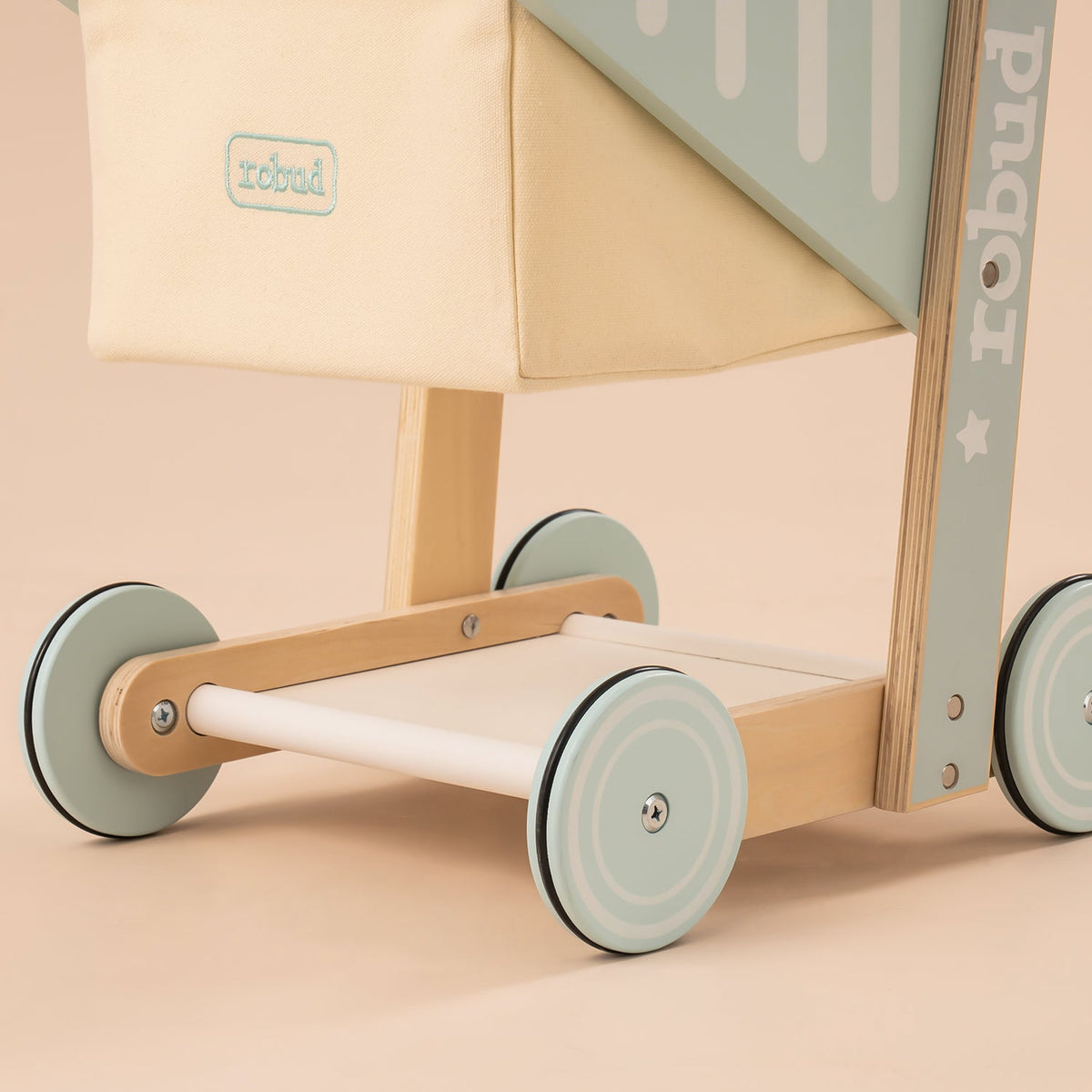ROBUD wooden baby push walker WRP02 wheel and base close-up showing sage green spokes and natural wood base frame