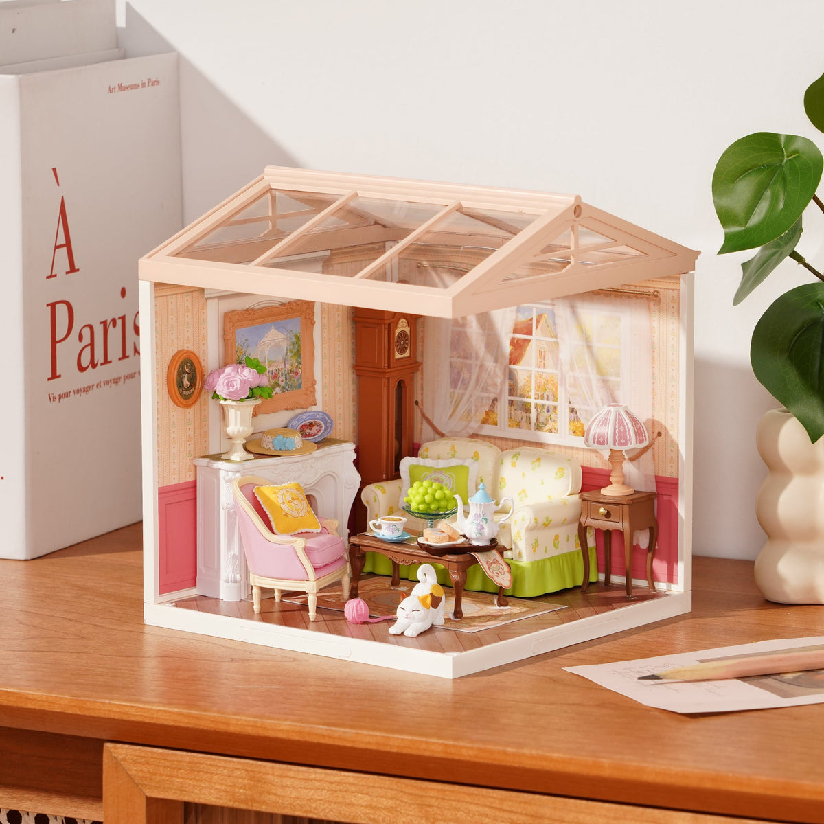 Rolife Holiday Tea Time DW023 miniature house on desk showing cozy tea-room interior with pastel furniture and potted plants