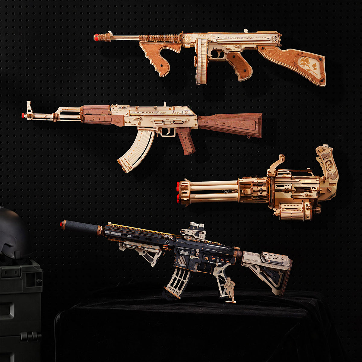 Set of four wooden puzzle gun models including a Thompson submachine gun, an AK rifle and two modern tactical rifles.