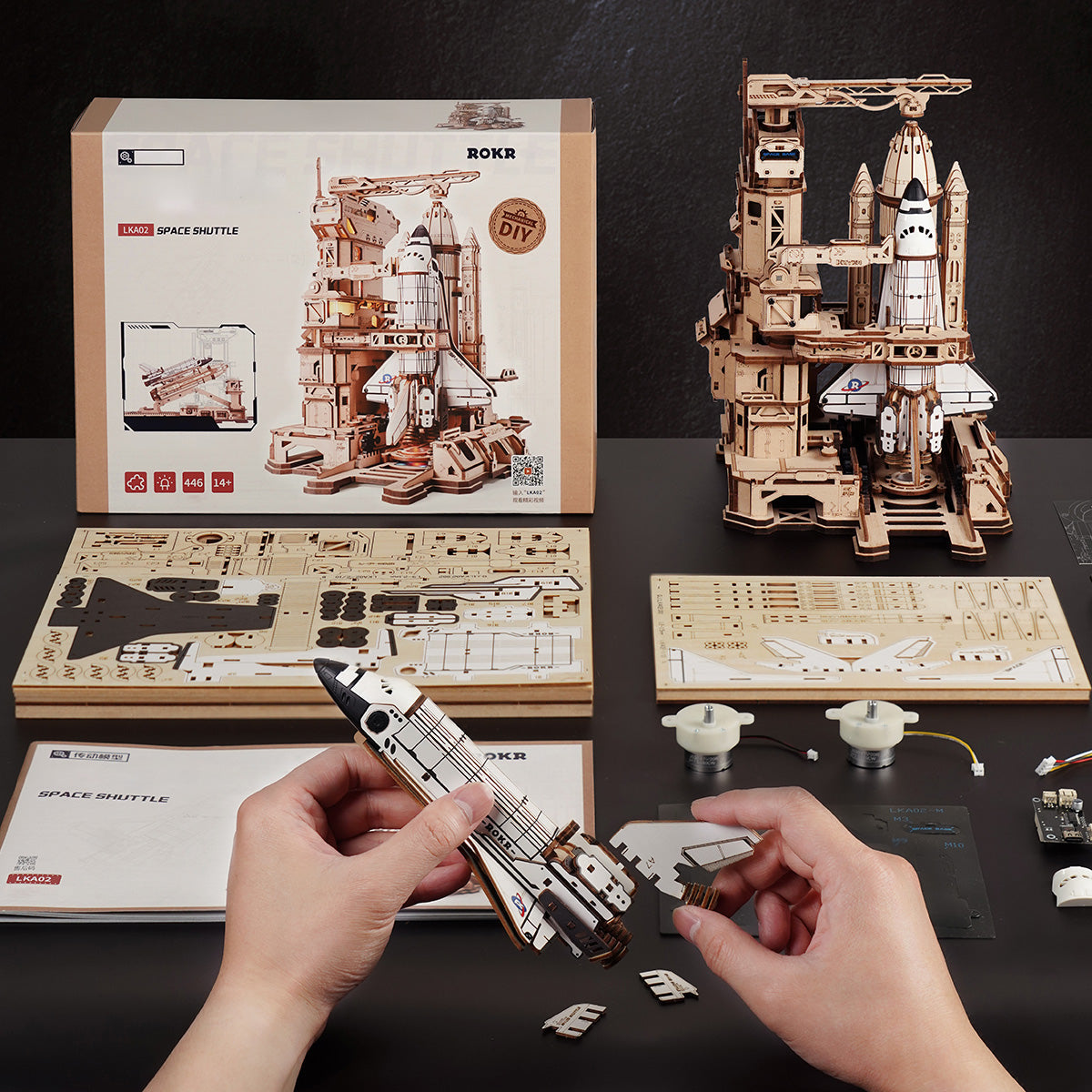 ROKR Space Shuttle LKA02 wooden puzzle retail box showing front and back with diagram labels, assembled dimensions of 249 by 196 by 272 mm, and other model suggestions
