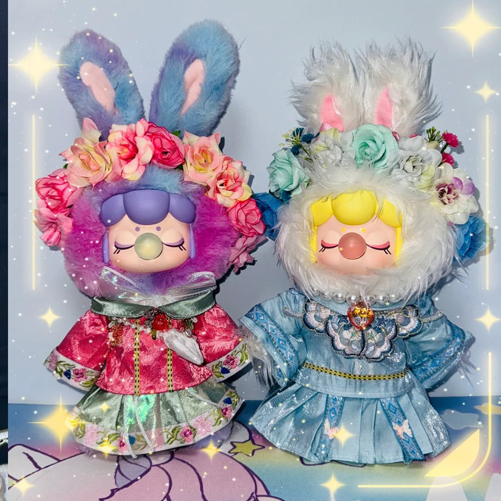 Two Rolife surprise figure dolls in elaborate floral dresses with sparkle backdrop