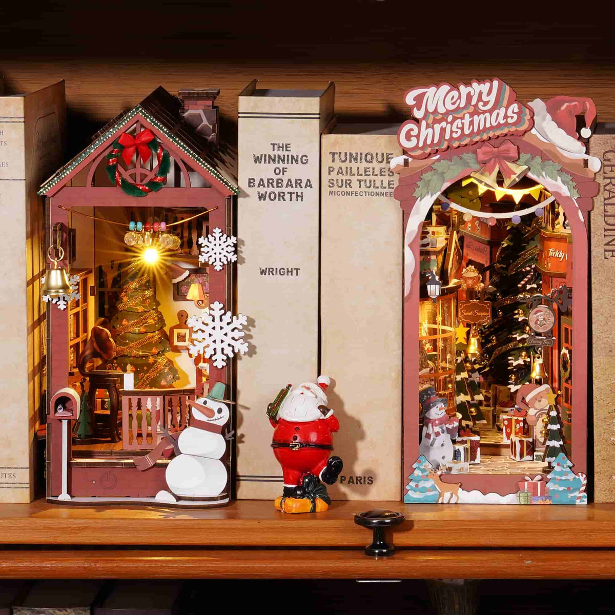 Rolife Christmas book nook kits displayed together with boxes, snowman, and Santa figure.