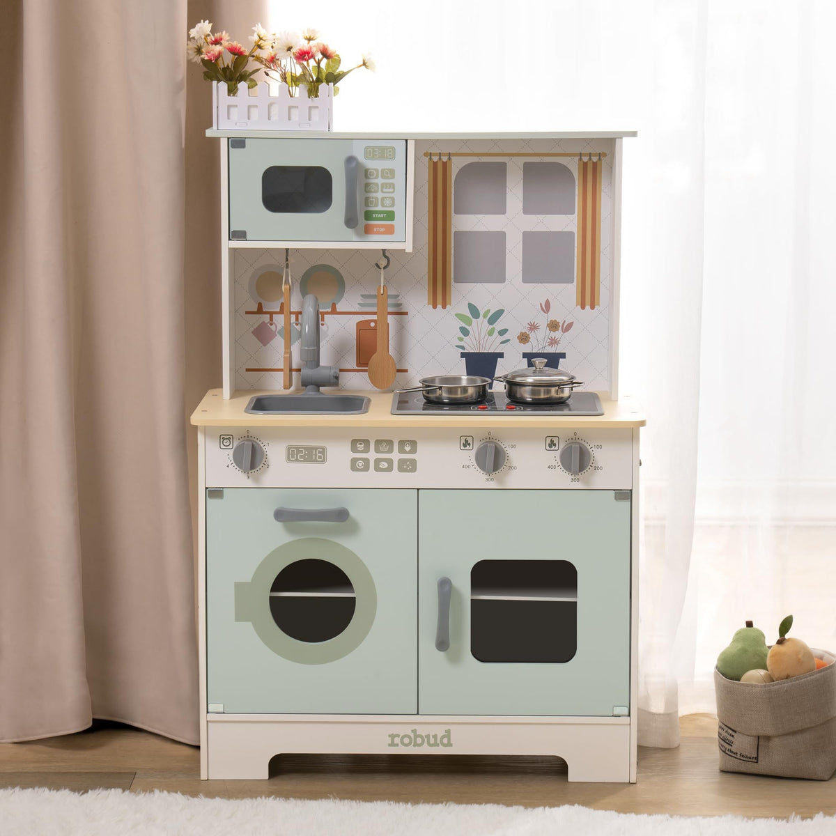 Robud green modern wooden play kitchen showing upper shelf with microwave and stovetop with gold knobs.
