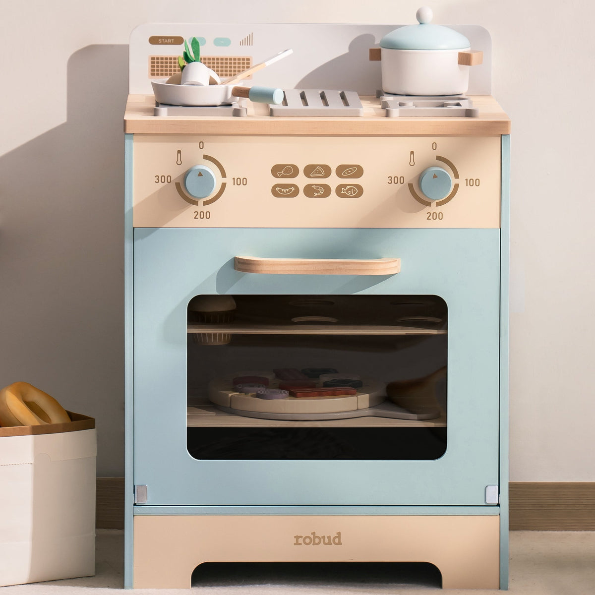 Robud wooden play oven with gas burner cooktop, close-up showing knobs and stovetop with teapot