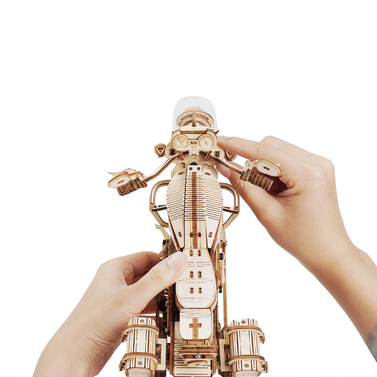 Hands fitting a dome helmet onto a ROKR wooden robot astronaut mechanical figure with gear details