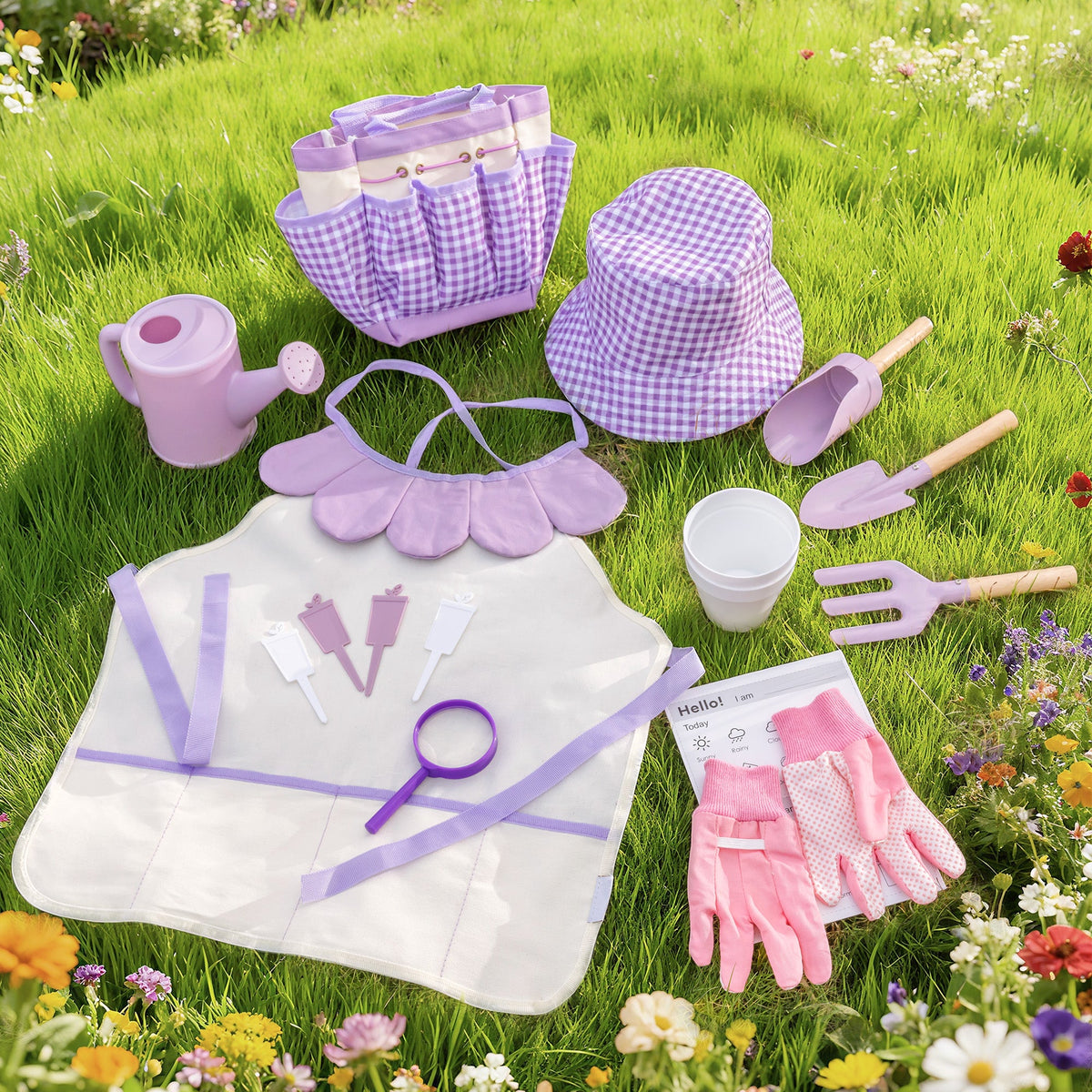 ROBUD Kids Gardening Set pink edition full contents laid flat on white showing tote bag, hat, apron, shovel, rake, fork and gloves