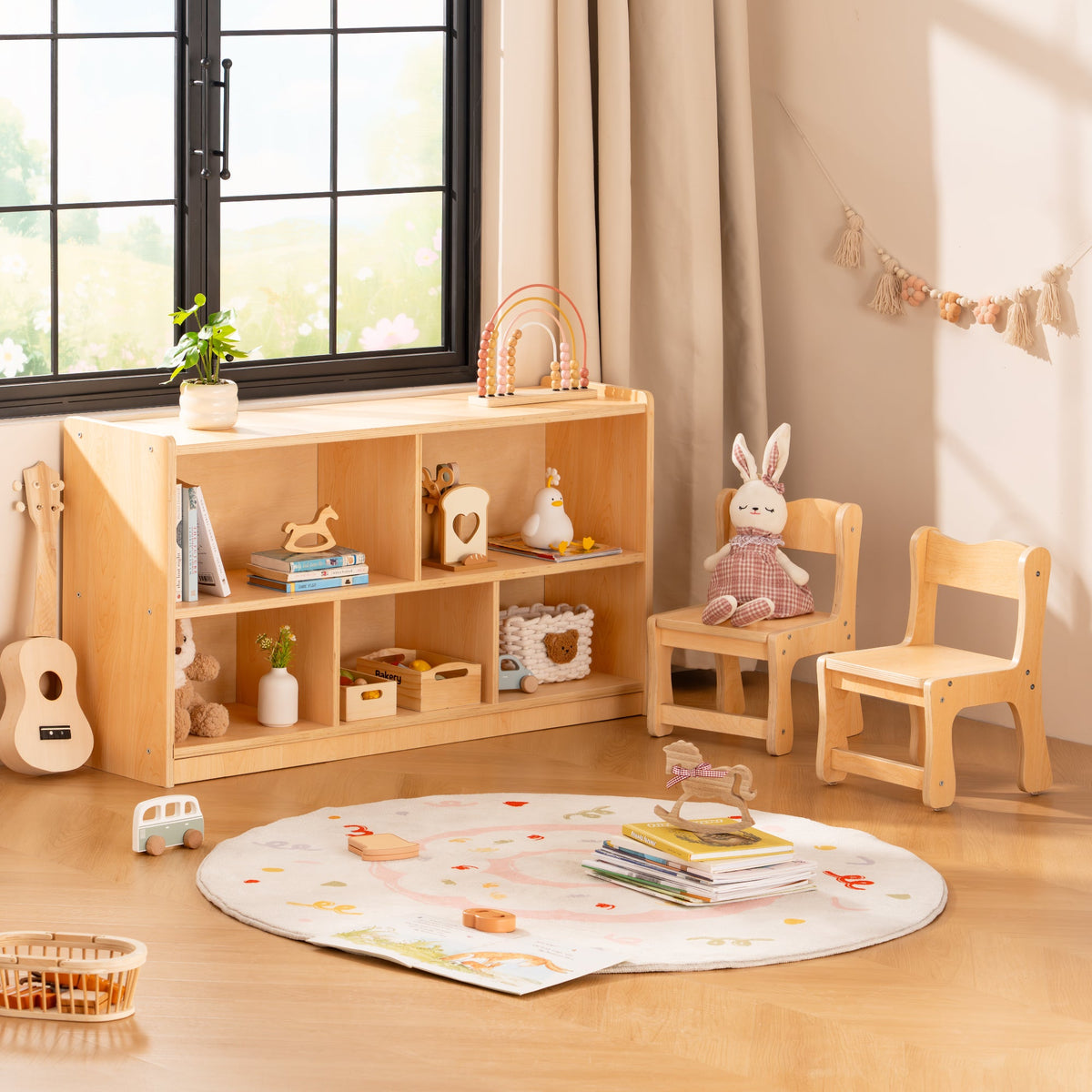 ROBUD wooden bookshelf styled beside a sunny window with stuffed animals baskets and colourful toys on its shelves.