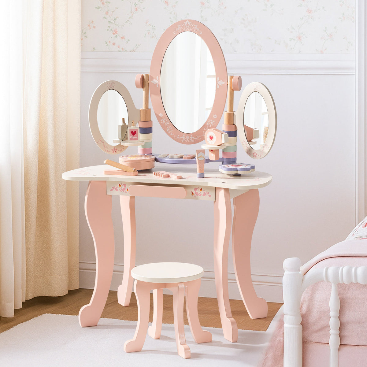 ROBUD pink wooden kids vanity with tri-fold mirror and matching stool displayed in a soft pink bedroom setting.