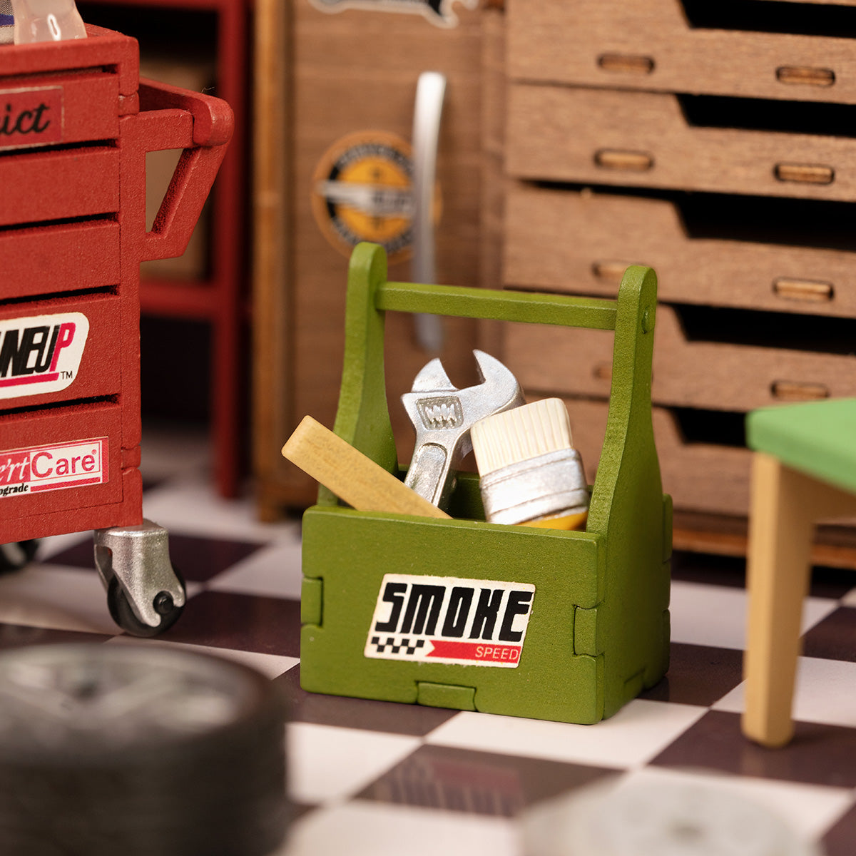Rolife Garage Workshop miniature close up showing green Smoke toolbox and red Snap on service cart