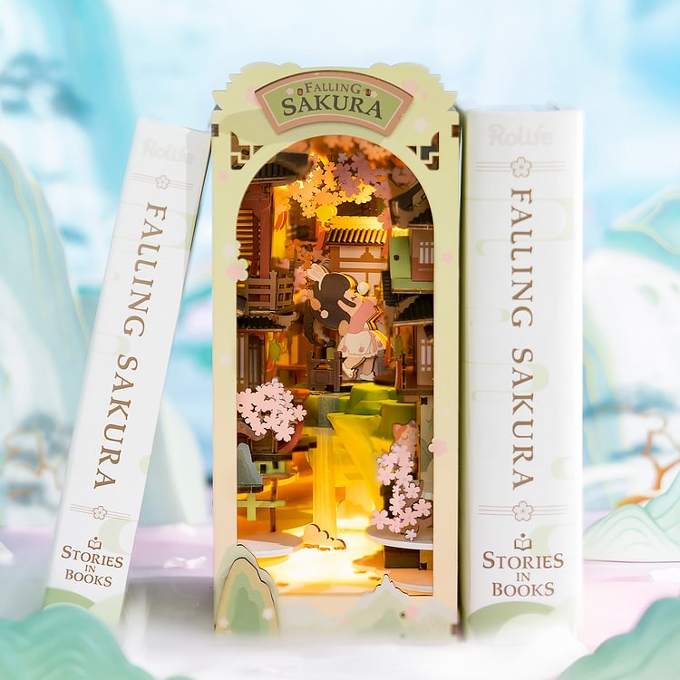 Rolife Falling Sakura book nook flanked by two matching spines, lit cherry blossom courtyard glowing inside