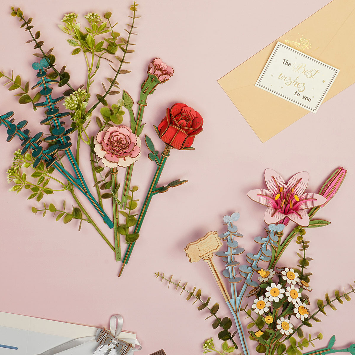 Rowood wooden flower puzzle pieces laid flat on a pink surface including tall stems, a lily and wildflower sprigs with an envelope